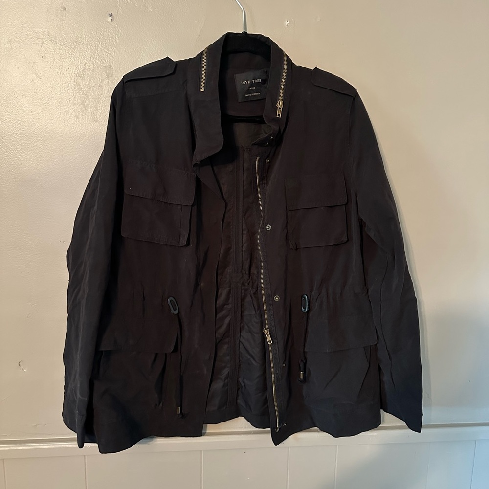 Black lightweight jacket with zippers.